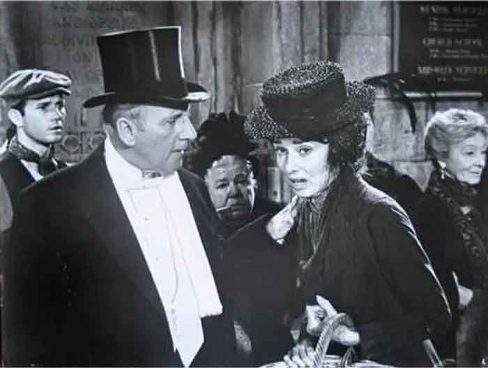 Christopher Riordan, Wilfrid Hyde-White and Audrey Hepburn in the film My Fair Lady.